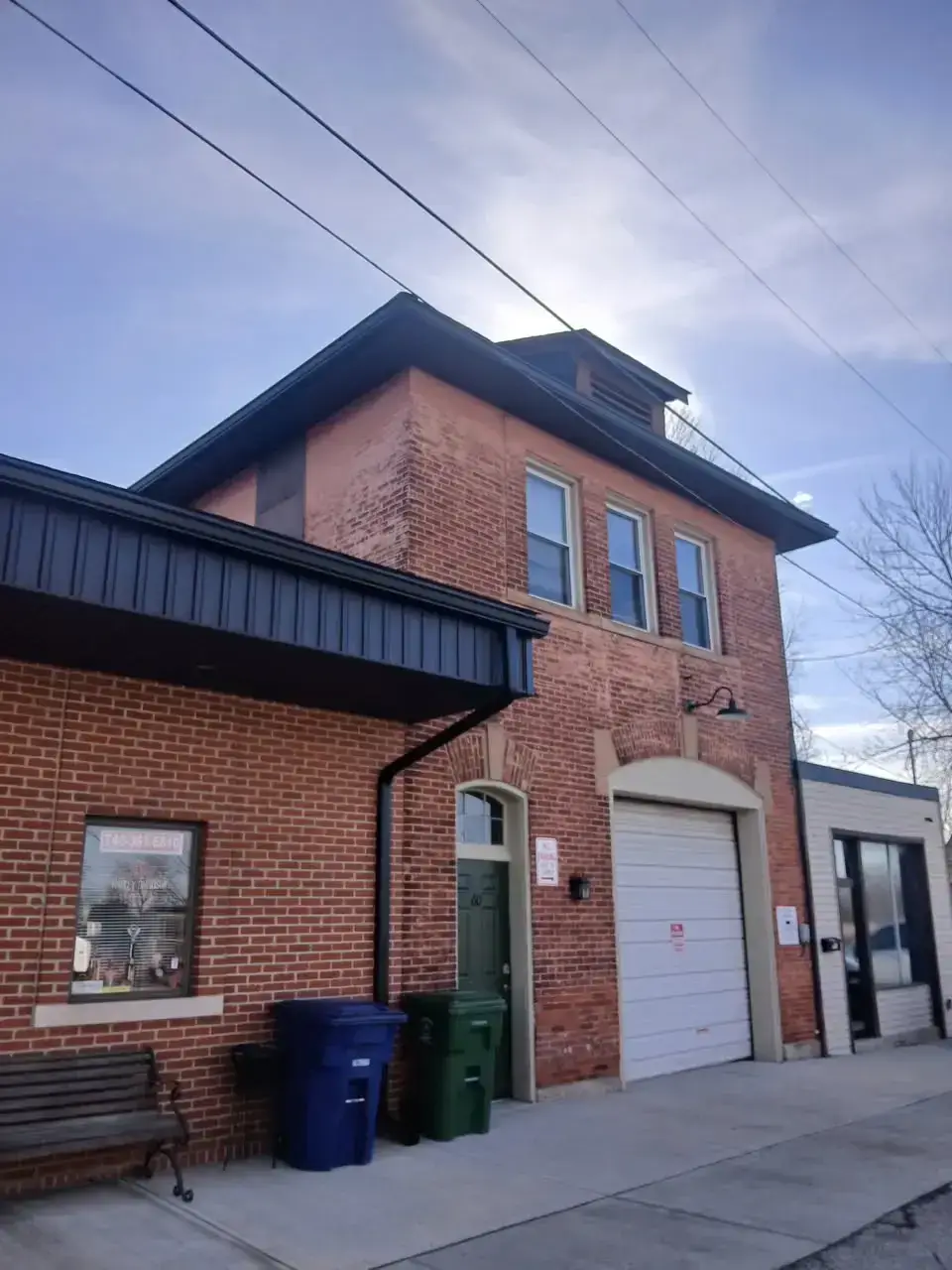 New black metal roof and matching soffit on a two-storey brick commercial building in Zanesville, Ohio